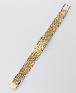 A lady's 9ct gold Omega wristwatch contained in a 15mm case on a ditto mesh bracelet, gross weight including glass 31.4 grams 