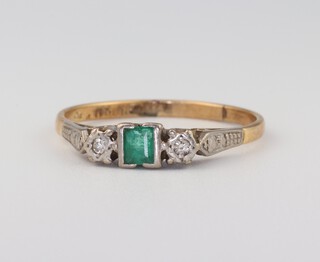 An 18ct yellow gold emerald and diamond ring, the square cut emerald 0.20ct, the 2 diamonds approx. 0.04ct, size T 1/2, 2.7 grams 