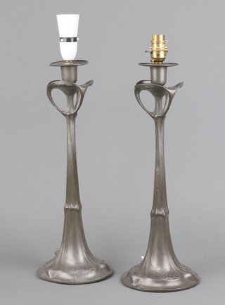 Kayserzinn, a pair of Art Nouveau pewter candle sticks by Hugo Leven for J P Kayser 42cm h x 15cm, the base marked Kayserzinn 4427, converted for use as table lamps with modern fittings 