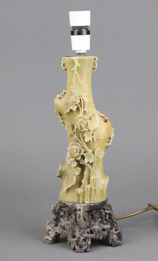 A carved and pierced soapstone table lamp with floral decoration 32cm x 13cm 