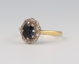 An 18ct yellow gold oval sapphire 1.0ct and diamond 0.10ct cluster ring size N, 3.6 grams 