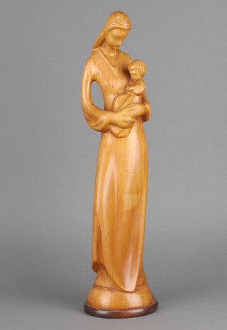 A carved yew figure of a standing mother and child 42cm h x 10cm 