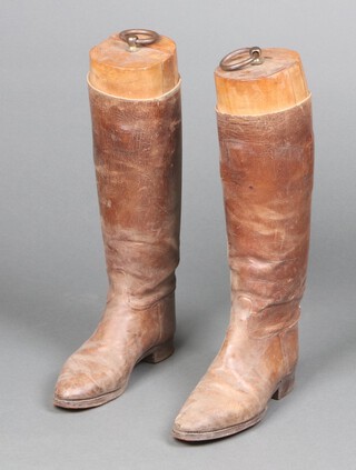 A pair of child's 19th/20th Century leather riding boots (sole 26cm l x 8cm w) complete with wooden trees 