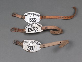 3 City of London black and white enamelled Market Porter's armbands nos. 381, 1332 and 1333 with leather straps and buckle