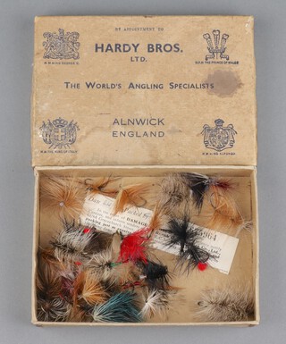 A 1930's Hardy cardboard box containing approx. 30 large fishing flies with compliment slip dated 1938 