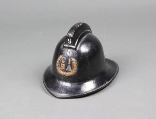 Of Horsham Interest, a black fireman's helmet by Helmets Ltd for use by the CIBA (later Ciba-Geigy) Pharmaceutical's company internal fire service, in plastic and cork with gold C.I.B.A letter above a wreath to front, inside size label 6 7/8 | 56