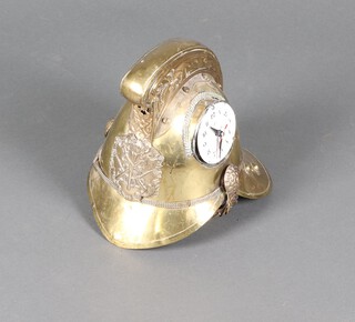 A fireman's Merryweather pattern brass helmet, the side inset a later poorly fitted electric clock 