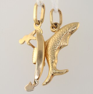 An 18ct yellow gold fish charm and a ditto gondola charm, 2.3 grams 