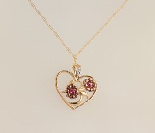 A 9ct yellow gold ruby 0.6ct and diamond 0.01ct heart shaped pendant decorated 2 flowers and chain 42cm, 2.1 grams 