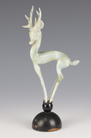 Istvan Komaromy, a glass lamp work figure of a deer with mottled green decoration standing on a ball with turned wooden base 21cm