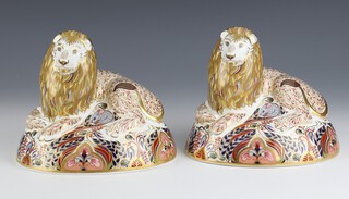 A pair of Royal Crown Derby Imari pattern  paperweights in the form of a reclining lion both with silver stoppers marked LX, 14cm (1 a second) 