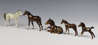 A Beswick brown gloss figure of a foal 11cm, ditto 8cm, another 7cm, reclining ditto 12cm and a white matte horse 10cm 