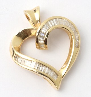 A 14ct yellow gold heart shaped pendant set with tapered baguette diamonds approx. 0.5ct, 25mm, 3.7 grams