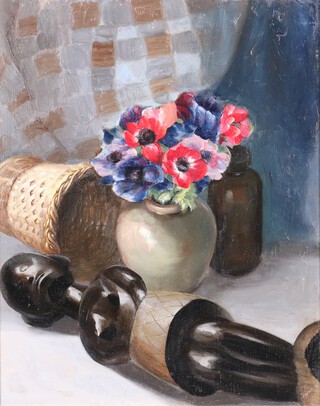 H Segal, oil on canvas, still life study of a carved African figure with vase of flowers, waste bin and bottle, label on verso