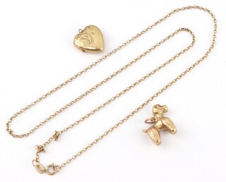 A 9ct yellow gold necklace 46cm, a poodle charm and a heart shaped locket, 4.9 grams 