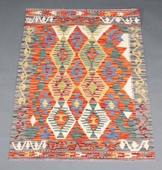 A yellow, orange and green ground Chobi Kilim rug with overall diamond design 125cm x 95cm 