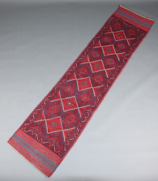 A red and blue ground Meshwani runner with 6 diamonds to the centre 261cm x 62cm 