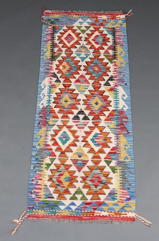 A white, orange and green ground Chobi Kilim runner with all over geometric designs 156cm x 60cm 