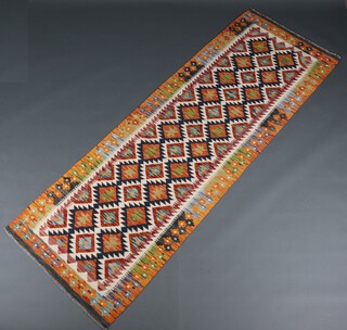 A white, black and orange ground Chobi Kilim runner with all over geometric designs 256cm x 86cm 