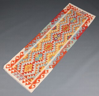 A white, gold and turquoise ground Chobi Kilim runner with over all geometric design 200cm x 67cm 