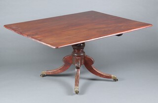 A 19th Century rectangular mahogany snap top breakfast table, raised on a turned column and tripod base, brass caps and casters 71cm h x 144cm w x 116cm d 