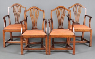 A set of 4 Georgian mahogany Hepplewhite style open arm carver chairs with pierced vase shaped slat backs, upholstered drop in seats, raised on square tapered supports  91cm h x 52cm w x 42cm d (seats 26cm x 26cm) together with a similar armchair 93cm h x 54cm w x 43cm d (seat 24cm x 27cm, break to back right hand arm) 