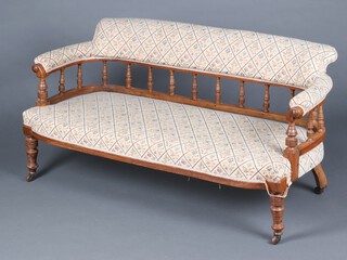 A Victorian mahogany sofa with bobbin turned decoration, upholstered in tapestry material, raised on turned supports with ceramic casters 64cm h x 143cm w x 57cm d (seat 110cm x 48cm) 