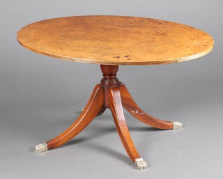 A Georgian style oval figured walnut coffee table raised on a pillar and tripod base, paw feet 56cm h x 101cm w x 76cm d 