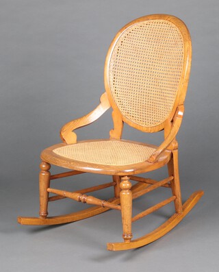 A Victorian elm rocking chair with woven cane seat and back 87cm h x 77cm w x 50cm d (seat 30cm x 32cm) 