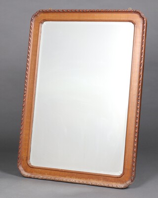 A 19th Century Continental arched bevelled plate mirror contained in a carved walnut frame 109cm x 78cm 