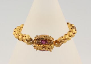 A Victorian gilt bracelet set with foil back gems 