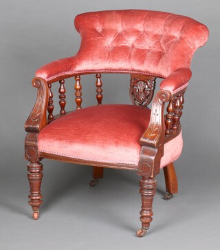 A Victorian mahogany tub back chair with spindle decoration, upholstered in rose pink buttoned material, raised on turned supports with ceramic casters 77cm h x 60cm w x 50cm d (seat 29cm x 36cm) 