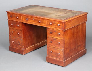 A Victorian mahogany kneehole pedestal desk with green inset writing surface above 1 long and 8 short drawers, raised on ceramic casters  72cm h x 122cm w x 68cm w 