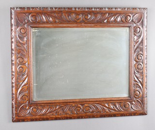 A Victorian rectangular bevelled plate wall mirror contained in a carved oak frame 60cm x 76cm 