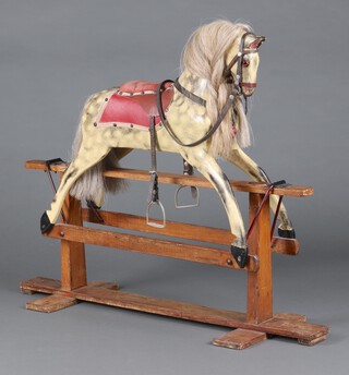 A dapple grey rocking horse, raised on a wooden H framed base 90cm h x 107cm x 36cm 