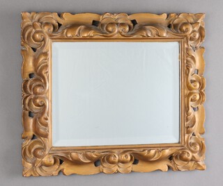 A rectangular bevelled plate wall mirror contained in a pierced carved and gilt painted frame 34cm x 41cm 