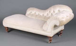 A Victorian chaise longue upholstered in cream buttoned material, raised on turned supports 77cm h x 178cm w x 63cm d (seat 100cm x 37cm) 