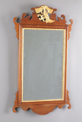 A 1920's Chippendale style mirror contained in a walnut frame surmounted by a phoenix 27cm x 39cm 