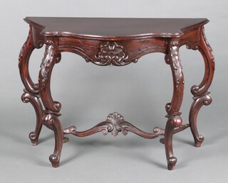 An Art Nouveau carved and pierced mahogany console table of serpentine outline, raised on cabriole supports with pierced and carved stretcher 75cm h x 101cm w x 45cm d 