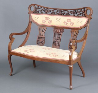 An Edwardian Art Nouveau pierced and carved mahogany double chair back settee, the seat of serpentine outline raised on cabriole supports 90cm h x 107cm w x 53cm d (seat 70cm x 40cm) 