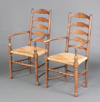 A pair of 18th Century style  beech ladder back carver chairs with  woven cane seats 105cm h x 58cm w x 47cm d (seat 30cm x 26cm) 