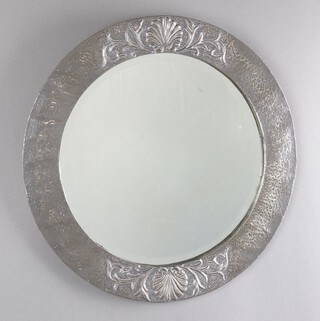 An Art Nouveau circular bevelled plate wall mirror contained in an embossed pewter frame decorated shells 50cm 