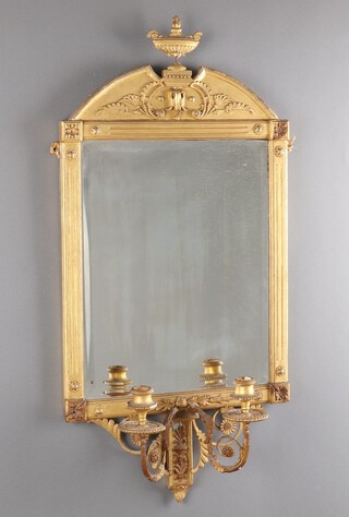 A 19th Century rectangular bevelled plate mirror contained in an arched gilt painted, wooden and plaster frame surmounted by an urn, the base with 2 candle sconces 87cm x 41cm 