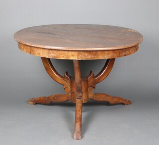 A 19th Century circular Italian walnut dining table, raised on horse head supports, turned tripod and hoof base 70cm h x 115cm diam. 