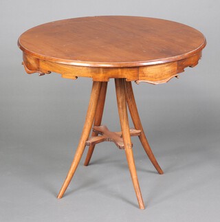 A circular Italian walnut centre table fitted 4 drawers to the shaped apron with cross shaped stretcher, raised on turned outswept supports 79cm h x 89cm diam. 