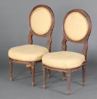 A pair of 1920's French carved beech salon chairs with upholstered seats and backs, raised on turned and fluted supports 82cm h x 40cm w x 40cm d (seats 25cm x 25cm), 1 labelled to the underside Charles Bernel Fabricant