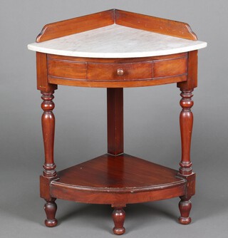 A Victorian mahogany corner wash stand with gallery to the back and white veined marble top, the base fitted a drawer above recess, raised on turned supports, the interior labelled J M Pym & Sons, Complete House Furnishings, Belper" 81cm h x 48cm w x 48cm d 