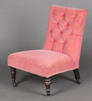 A Victorian nursing chair upholstered in pink buttoned material, raised on turned ebonised supports, ceramic casters 67cm h x 48cm w x 50cm d (seat 30cm x 30cm) 