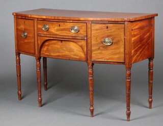 A Georgian mahogany bow front sideboard fitted a drawer above secret drawer, flanked by a cellarette drawer and cupboard enclosed by panelled door, raised on turned supports 91cm h x 137cm w x 61cm d 