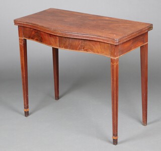 An Edwardian, Georgian style inlaid mahogany tea table of serpentine outline, raised on square tapered supports, spade feet 75cm h x 90cm w x 45cm d 